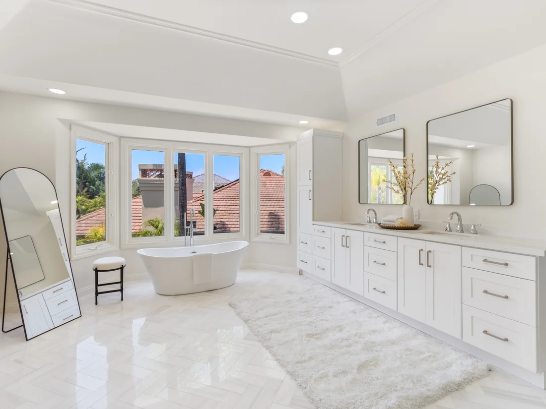 Resort-feel primary bath in Coto de Caza with freestanding tub and herringbone marble floors